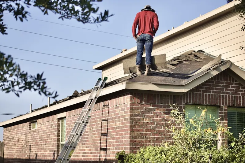 Professional roofer working on a residential roof in East Davis